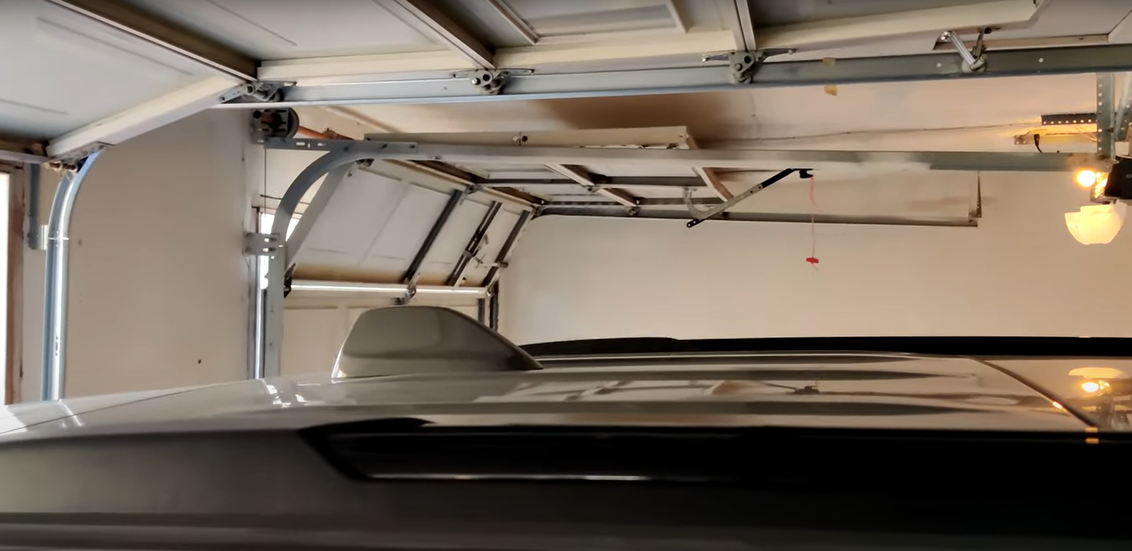 Overhead garage door repair in Upper Arlington technician fixing a residential garage door with tools and replacement parts