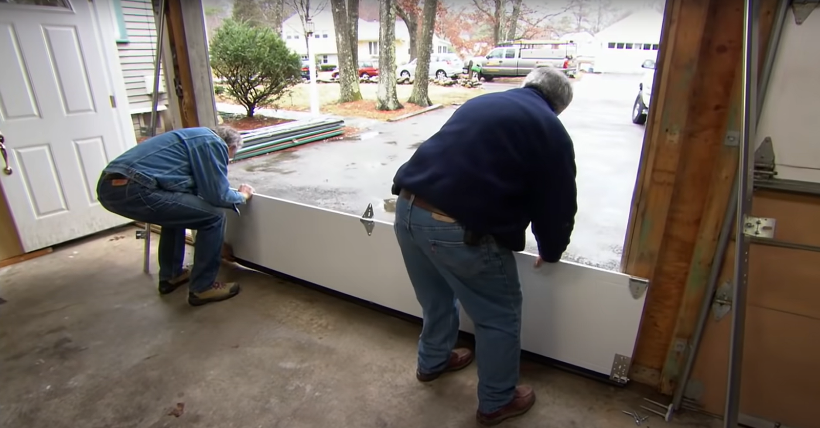 A professional technician performing garage door installation on a residential home in Upper Arlington.