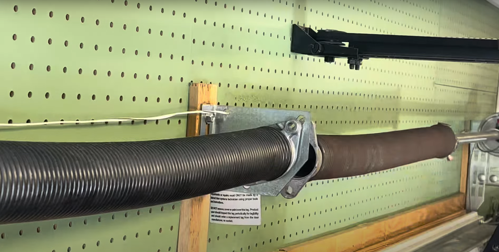 a broken garage door spring in Upper Arlington, illustrating a common issue requiring prompt repair by professional technicians.