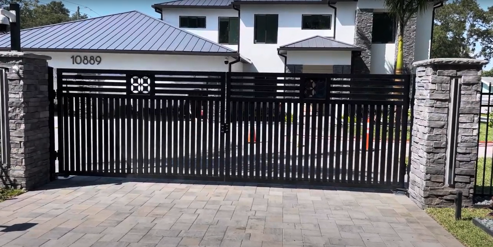 A technician performing commercial gate repair on a home in Upper Arlington, adjusting the gate's hinges and ensuring smooth operation for enhanced security and curb appeal.
