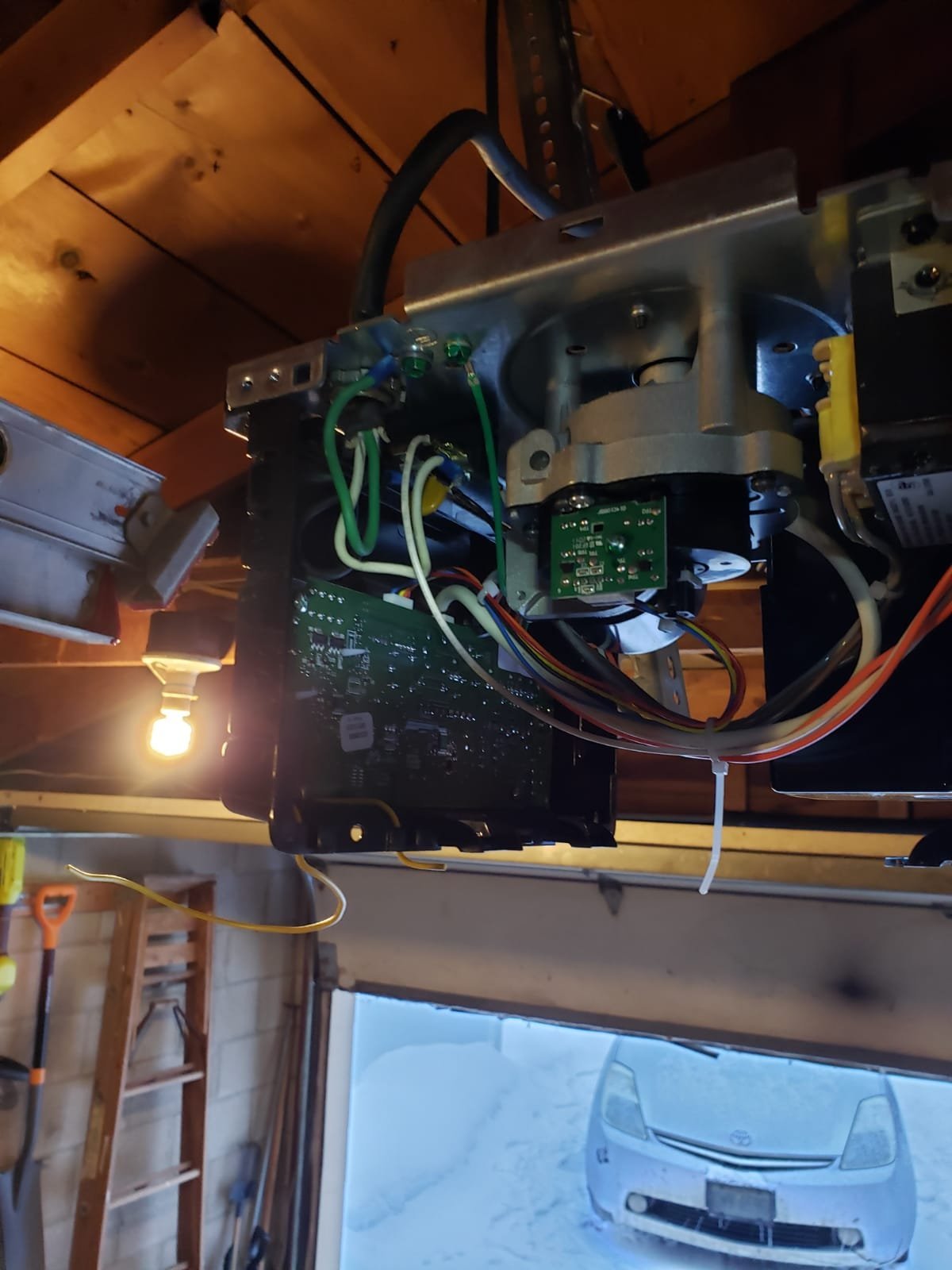 Technician repairing a garage door opener in Upper Arlington, ensuring smooth and reliable operation for local homeowners.