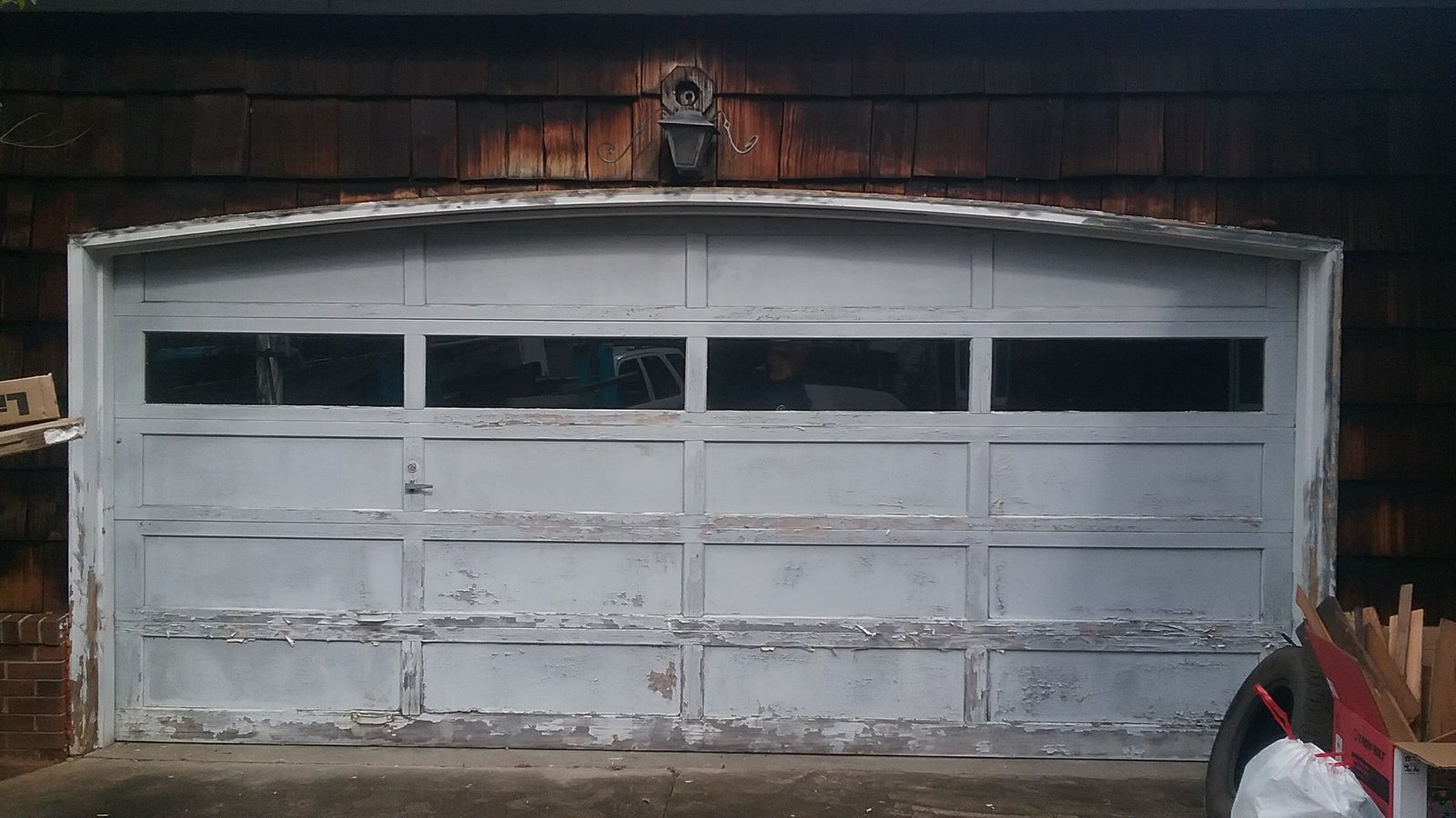 Garage door repair professional assessing a homeowner's garage door system