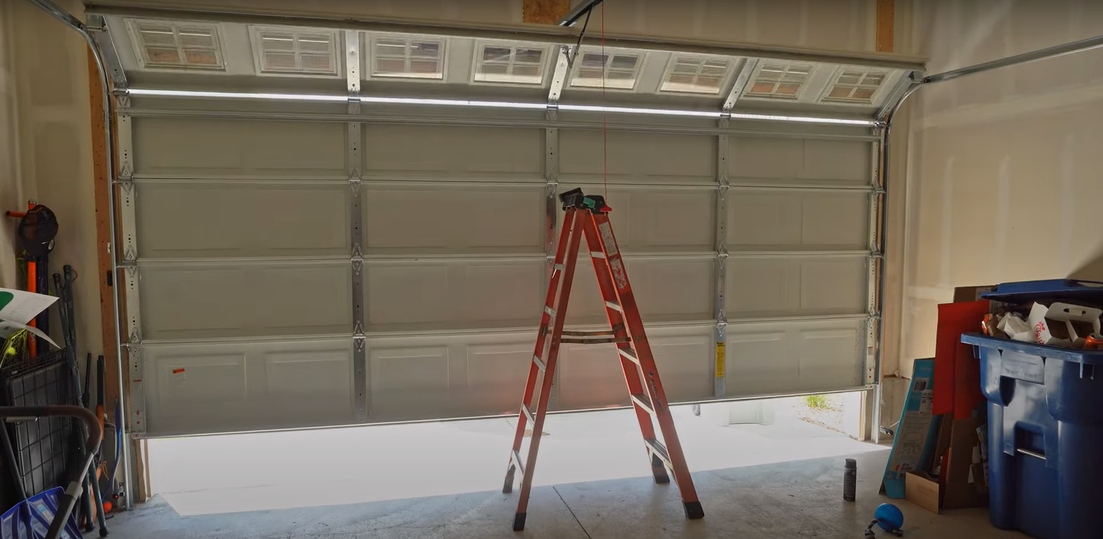Garage door repair professional assessing a homeowner's garage door system