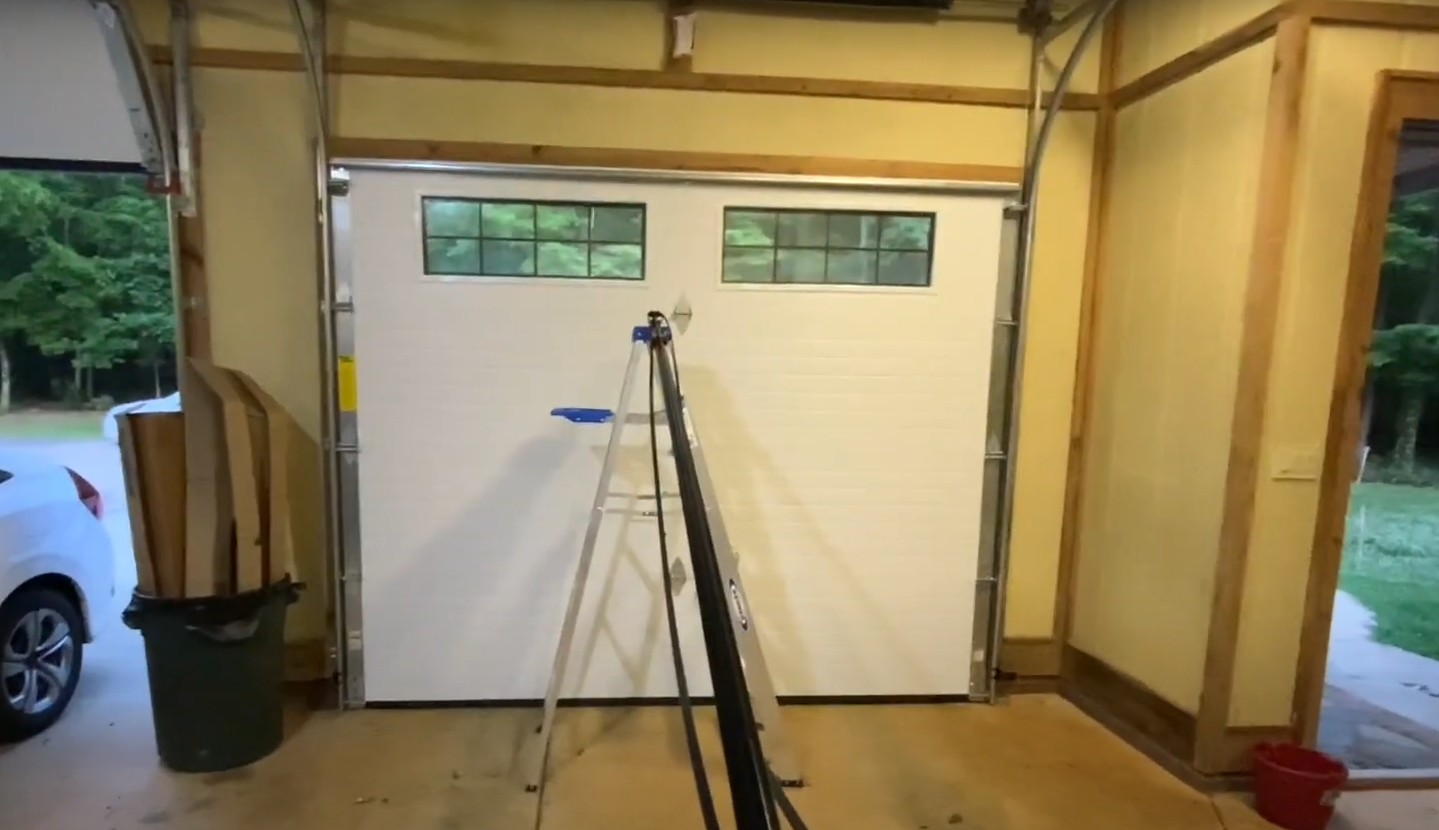 Garage door repair professional assessing a homeowner's garage door system